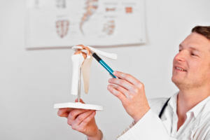 Shoulder Surgeon pointing at shoulder bone
