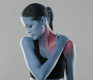 Studio shot of an athlete with an injury highlighted in glowing red -shoulder instability concept