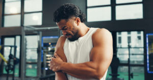 Male person with sore bicep or joint inflammation with ache caused due to bicep tendinopathy.