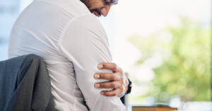 A man in pain caused by Bicep tendinopathy.